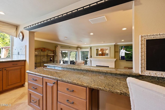 22671 Cheryl Way, Lake Forest, CA 92630 - kitchen with brown cabinetry, crown molding, recessed lighting, and light stone countertops