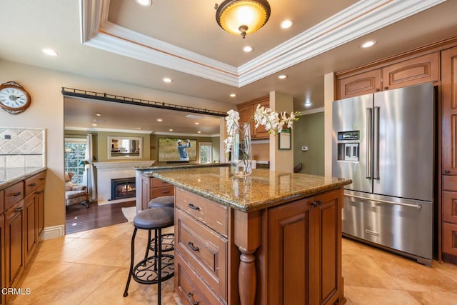 22671 Cheryl Way, Lake Forest, CA 92630 - kitchen featuring high end fridge, ornamental molding, a breakfast bar, a center island, and a lit fireplace