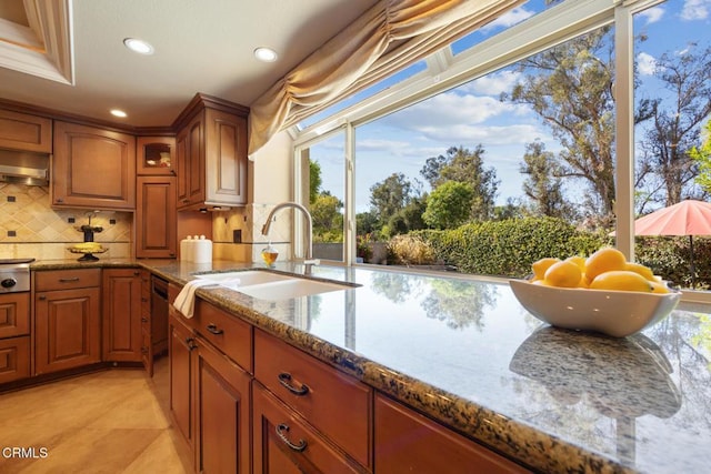 22671 Cheryl Way, Lake Forest, CA 92630 - kitchen featuring stone counters, recessed lighting, brown cabinets, tasteful backsplash, and healthy amount of natural light