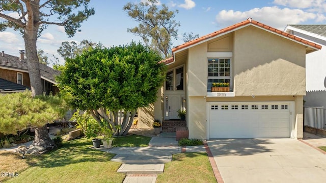 22671 Cheryl Way, Lake Forest, CA 92630 - view of front facade with concrete driveway, a garage, stucco siding, and a tile roof