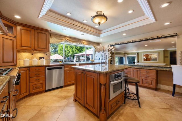22671 Cheryl Way, Lake Forest, CA 92630 - kitchen with stainless steel appliances, a raised ceiling, brown cabinetry, backsplash, and recessed lighting