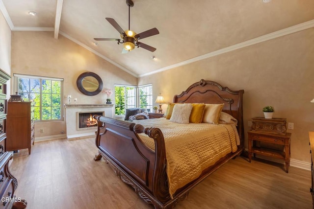 22671 Cheryl Way, Lake Forest, CA 92630 - bedroom with light wood-style flooring, multiple windows, a warm lit fireplace, beam ceiling, and high vaulted ceiling