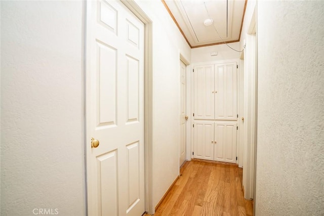 16372 Hollywood Ln, Huntington Beach, CA 92649 - hallway with a textured wall, crown molding, attic access, and light wood finished floors