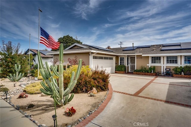 16372 Hollywood Ln, Huntington Beach, CA 92649 - ranch-style house featuring solar panels, a garage, and concrete driveway