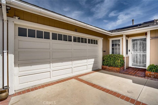 16372 Hollywood Ln, Huntington Beach, CA 92649 - garage with driveway and solar panels