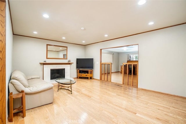 16372 Hollywood Ln, Huntington Beach, CA 92649 - living room with recessed lighting, ornamental molding, a fireplace with flush hearth, and wood finished floors