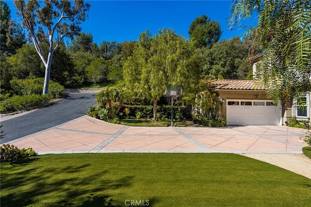 2107 Lemon Heights Dr, Santa Ana, CA 92705 - view of front of property with stucco siding, driveway, an attached garage, a front yard, and a tiled roof