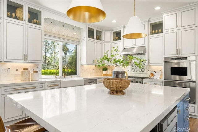 2107 Lemon Heights Dr, Santa Ana, CA 92705 - kitchen featuring stainless steel double oven, under cabinet range hood, a sink, a center island, and pendant lighting