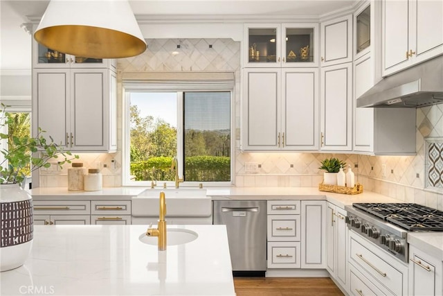 2107 Lemon Heights Dr, Santa Ana, CA 92705 - kitchen featuring a sink, light countertops, under cabinet range hood, stainless steel appliances, and decorative backsplash