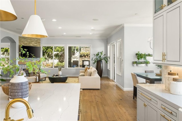 2107 Lemon Heights Dr, Santa Ana, CA 92705 - living room with light wood-style flooring, arched walkways, baseboards, recessed lighting, and ornamental molding