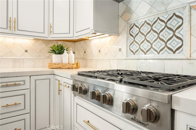 2107 Lemon Heights Dr, Santa Ana, CA 92705 - kitchen with stainless steel gas stovetop, light countertops, backsplash, and white cabinets