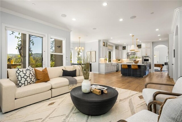 2107 Lemon Heights Dr, Santa Ana, CA 92705 - living room featuring arched walkways, light wood-style floors, crown molding, and recessed lighting