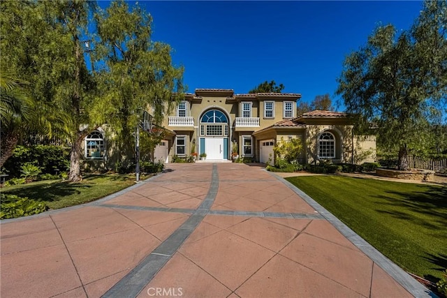 2107 Lemon Heights Dr, Santa Ana, CA 92705 - mediterranean / spanish home featuring a front lawn, stucco siding, driveway, and a balcony