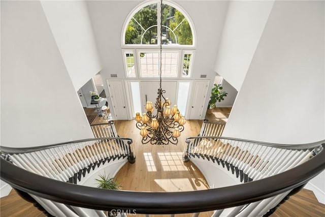 2107 Lemon Heights Dr, Santa Ana, CA 92705 - stairway with wood finished floors, a towering ceiling, and a chandelier