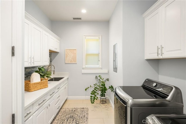 2107 Lemon Heights Dr, Santa Ana, CA 92705 - laundry room with a sink, baseboards, visible vents, cabinet space, and washer and dryer