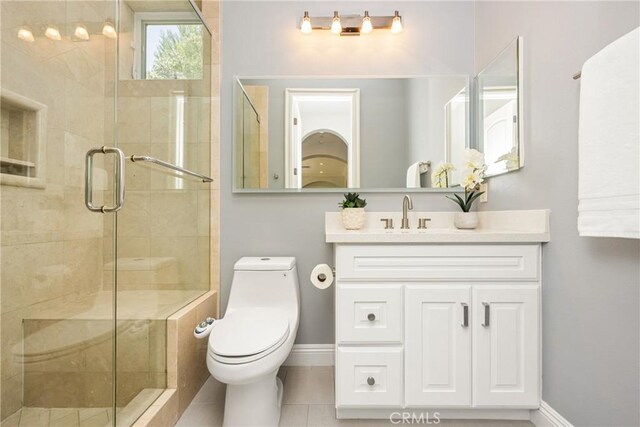 2107 Lemon Heights Dr, Santa Ana, CA 92705 - full bath featuring tile patterned floors, toilet, vanity, baseboards, and a stall shower