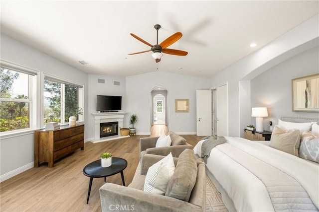 2107 Lemon Heights Dr, Santa Ana, CA 92705 - bedroom with arched walkways, light wood finished floors, baseboards, and multiple windows