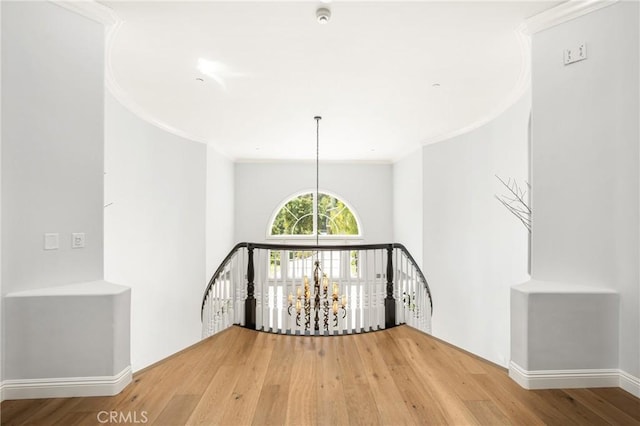 2107 Lemon Heights Dr, Santa Ana, CA 92705 - hall with an upstairs landing, a notable chandelier, ornamental molding, and wood finished floors