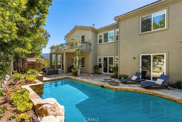 2107 Lemon Heights Dr, Santa Ana, CA 92705 - rear view of house with stucco siding, an outdoor pool, a patio, and a balcony