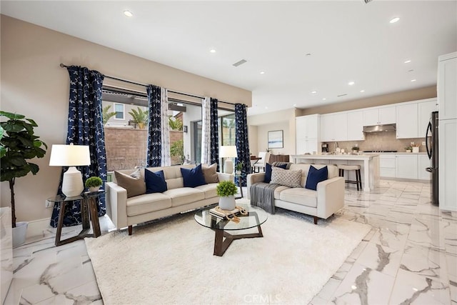 living area with marble finish floor and recessed lighting