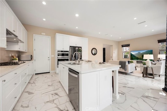 kitchen with visible vents, under cabinet range hood, recessed lighting, stainless steel appliances, and marble finish floor