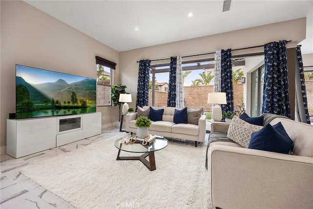 living area with visible vents, baseboards, recessed lighting, and marble finish floor