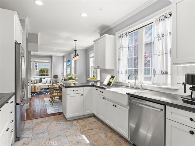 2155 Florence Ave, San Luis Obispo, CA 93401 - kitchen with stainless steel appliances, a sink, dark countertops, ornamental molding, and recessed lighting
