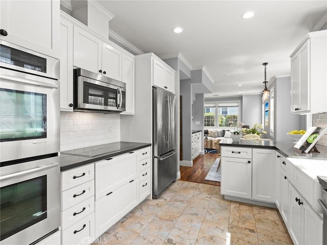 2155 Florence Ave, San Luis Obispo, CA 93401 - kitchen with stainless steel appliances, crown molding, recessed lighting, open floor plan, and dark countertops