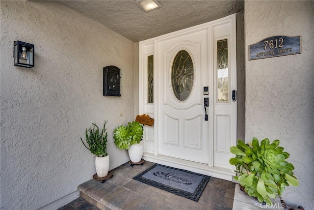 7612 Appleby, Huntington Beach, CA 92648 - doorway to property featuring stucco siding