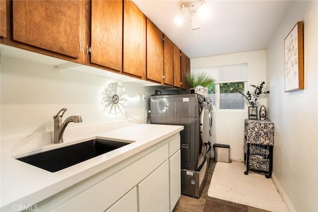 7612 Appleby, Huntington Beach, CA 92648 - clothes washing area with baseboards, separate washer and dryer, cabinet space, and a sink