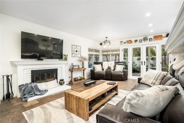 7612 Appleby, Huntington Beach, CA 92648 - living room featuring a brick fireplace, french doors, stone tile flooring, and plenty of natural light