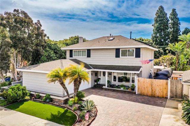 7612 Appleby, Huntington Beach, CA 92648 - traditional-style house with a gate, roof with shingles, a chimney, fence, and decorative driveway