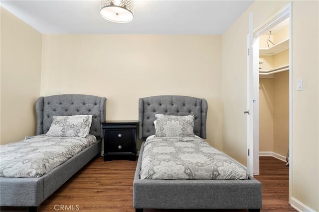 bedroom with baseboards and wood finished floors