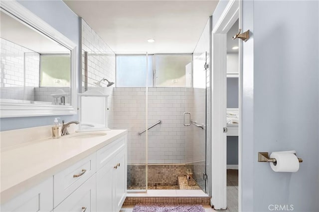 bathroom featuring a stall shower and vanity