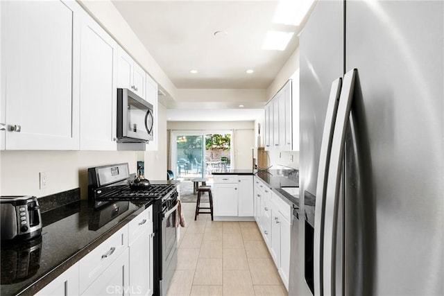 kitchen with recessed lighting, white cabinets, and appliances with stainless steel finishes