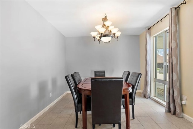 dining room featuring baseboards and a notable chandelier