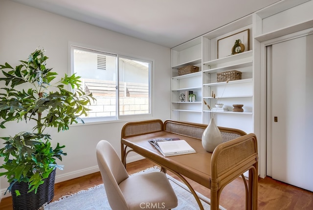 sitting room with wood finished floors and baseboards