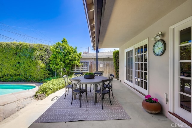 view of patio / terrace featuring a fenced in pool, outdoor dining area, and fence