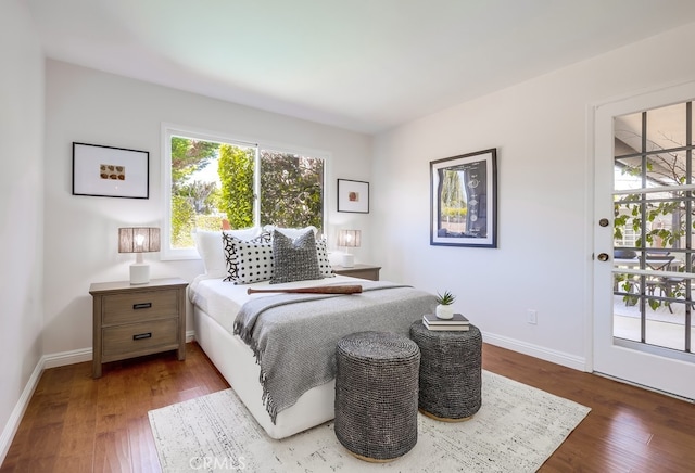 bedroom featuring baseboards and wood finished floors