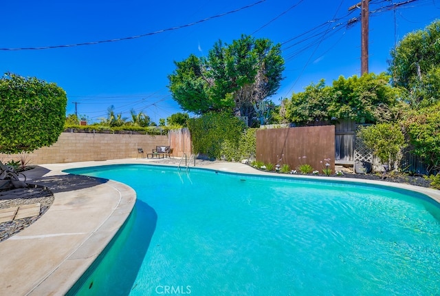 view of swimming pool featuring a fenced in pool and a fenced backyard