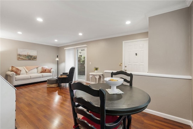 dining area featuring baseboards, ornamental molding, wood finished floors, and recessed lighting