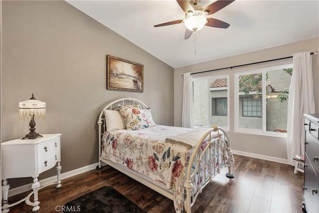 bedroom featuring dark wood-style floors, baseboards, a ceiling fan, and vaulted ceiling