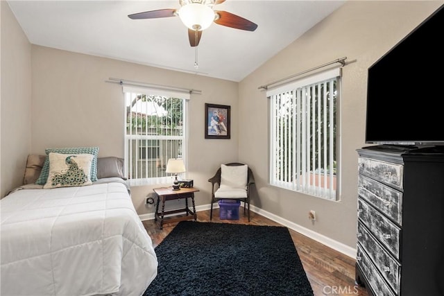 bedroom featuring baseboards, wood finished floors, ceiling fan, and vaulted ceiling