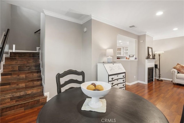dining space with stairway, visible vents, recessed lighting, ornamental molding, and wood finished floors