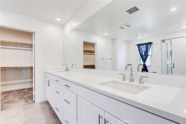 972 W Jasmine Way, Rialto, CA 92376 - bathroom with double vanity, a walk in closet, recessed lighting, a stall shower, and tile patterned floors