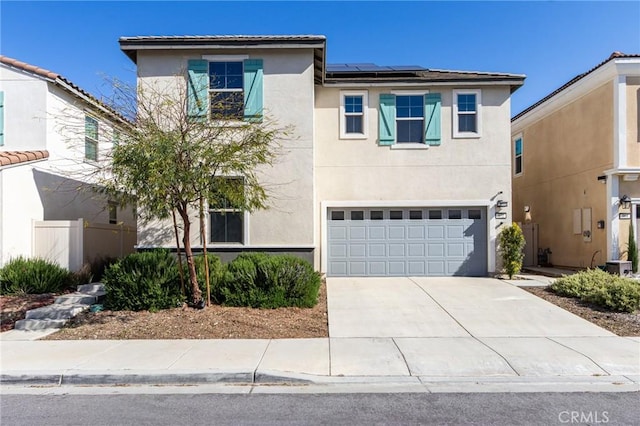 972 W Jasmine Way, Rialto, CA 92376 - traditional-style home with stucco siding, solar panels, a garage, and driveway