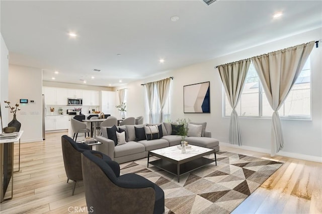 972 W Jasmine Way, Rialto, CA 92376 - living room featuring light wood-style flooring and recessed lighting