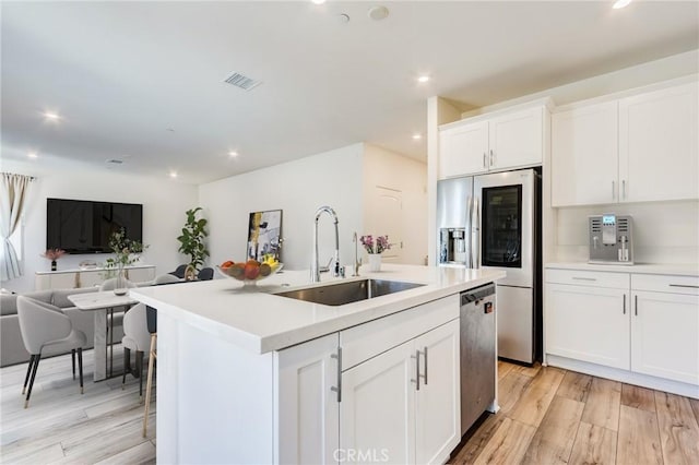 972 W Jasmine Way, Rialto, CA 92376 - kitchen featuring open floor plan, stainless steel appliances, white cabinetry, light countertops, and recessed lighting