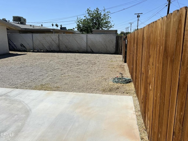 391 N 9th St, Blythe, CA 92225 - view of yard featuring a fenced backyard, central AC unit, and a patio