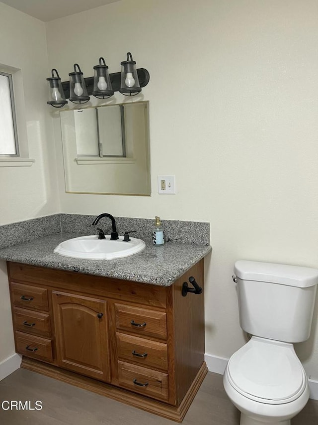 391 N 9th St, Blythe, CA 92225 - bathroom featuring toilet, vanity, and baseboards